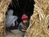 Boy Peeking out of Hut